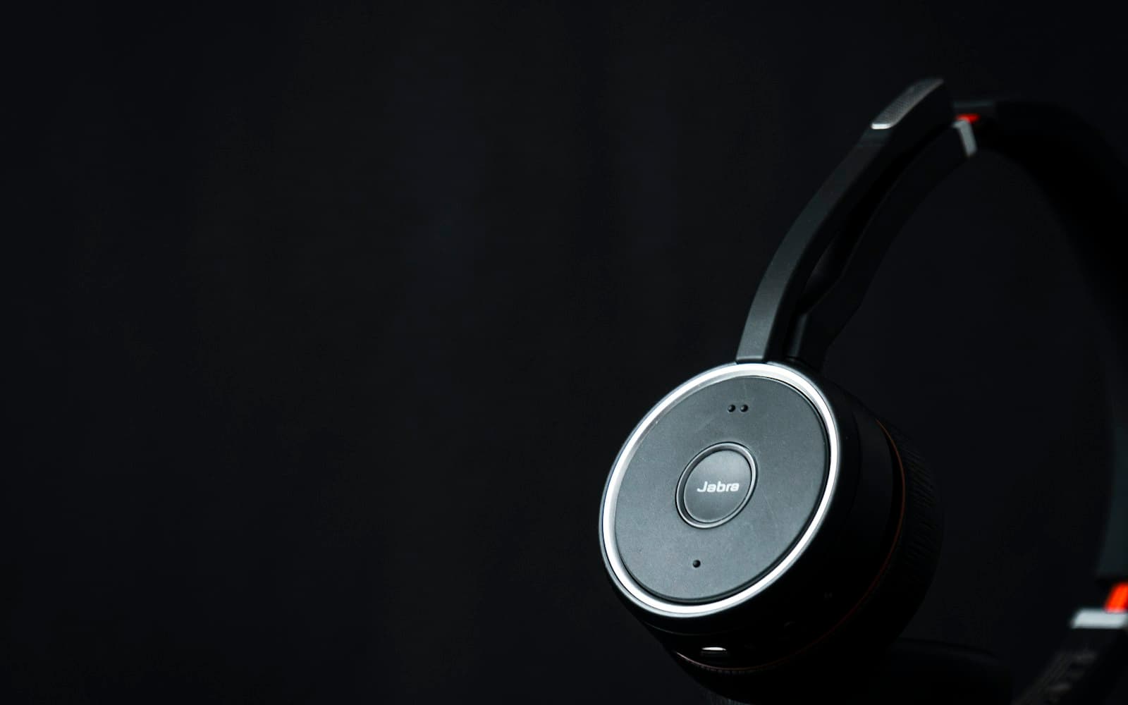 A support headset resting against a dark background